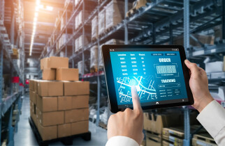 Sustainability Supply Chain - employee holding tablet in warehouse